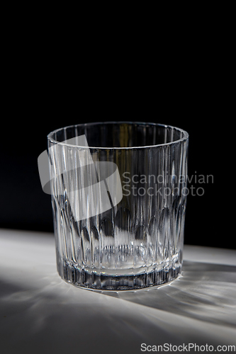 Image of empty faceted glass on table