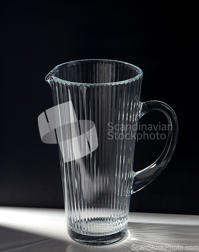 Image of empty faceted glass jug on table