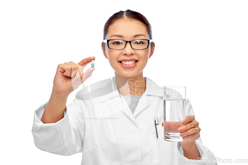 Image of asian doctor with medicine and glass of water