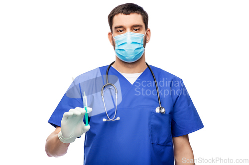 Image of male doctor in mask and gloves with syringe