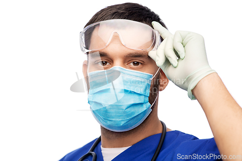 Image of male doctor in goggles, mask and gloves