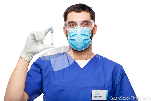 Image of male doctor in mask with blood in test tube