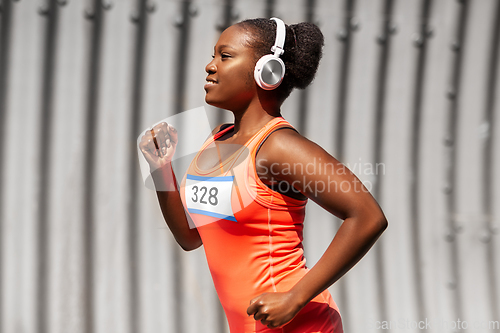 Image of happy african american woman running marathon