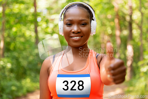 Image of happy female marathon runner with headphones