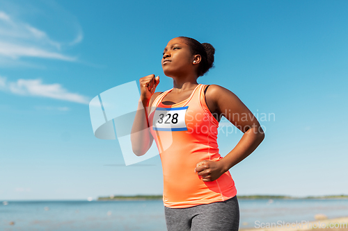 Image of young african american woman running marathon