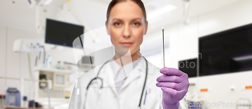 Image of female doctor with cotton swab at hospital