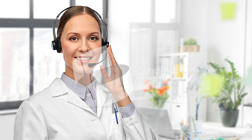 Image of smiling female doctor with headset at hospital