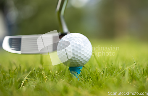 Image of Golf ball on tee in front of driver