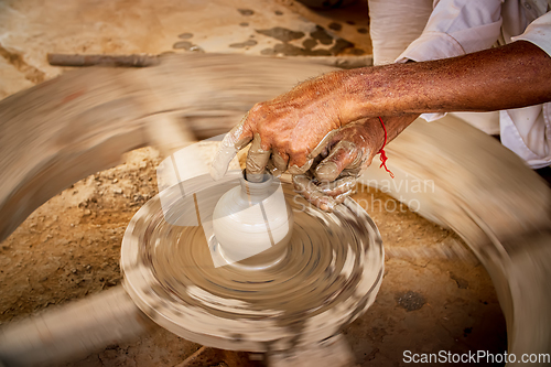 Image of Potter at work makes ceramic dishes. India, Rajasthan.