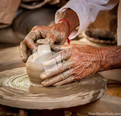 Image of Potter at work makes ceramic dishes. India, Rajasthan.