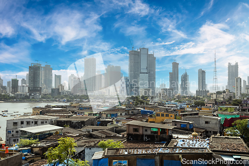 Image of Views of slums on the shores of Mumbai, India against the backdr