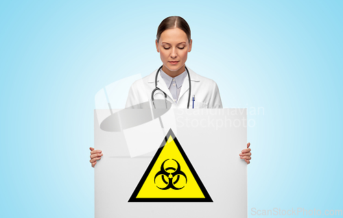 Image of female doctor with biohazard sign over blue