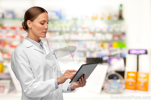 Image of female doctor with tablet computer at pharmacy