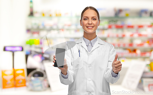 Image of female doctor with smartphone showing thumbs up