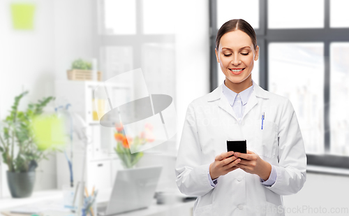 Image of happy female doctor with smartphone at hospital