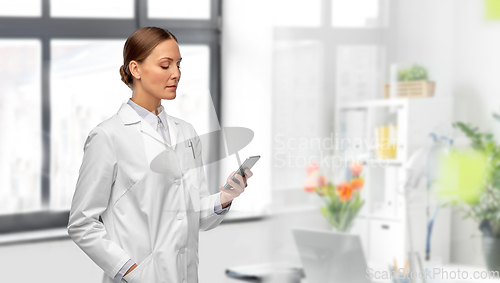 Image of female doctor with smartphone at hospital
