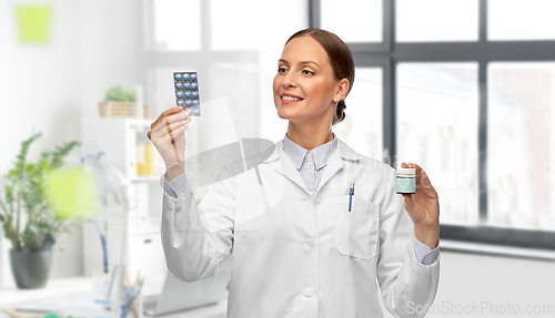 Image of female doctor holding medicine pills at hospital