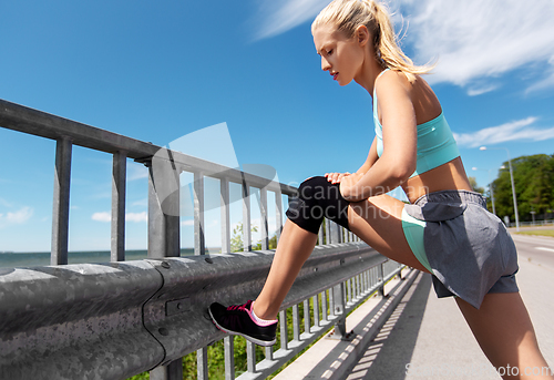 Image of young woman doing sports outdoors