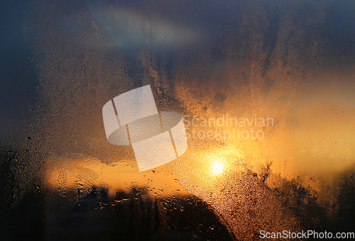 Image of Melting ice, water drops and sunlight in a winter morning on gla