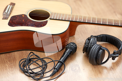 Image of close up of guitar, microphone and headphones