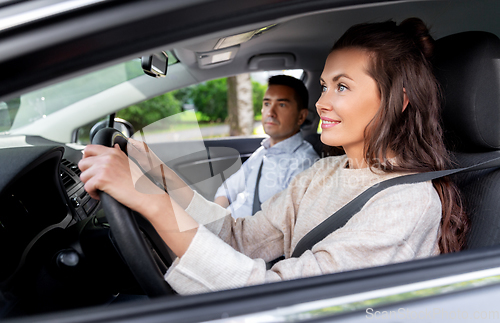 Image of car driving school instructor teaching woman