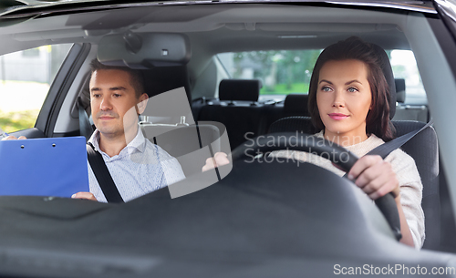 Image of car driving school instructor and young driver