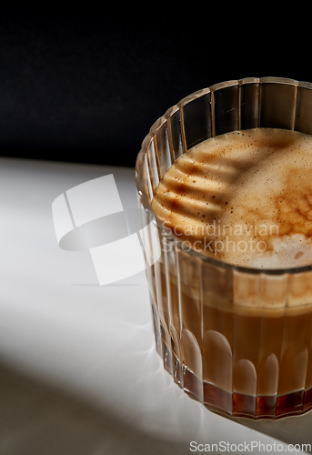 Image of close up of coffee in glass on table