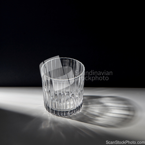 Image of empty faceted glass on table