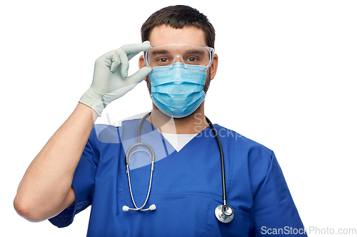 Image of male doctor in goggles, mask and gloves