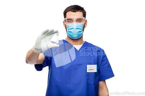 Image of male doctor in mask with blood in test tube