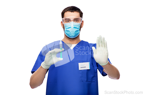 Image of male doctor in mask and gloves with syringe