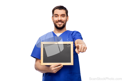 Image of happy smiling male doctor or nurse with chalkboard