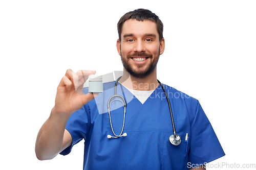 Image of doctor or male nurse with medicine and stethoscope