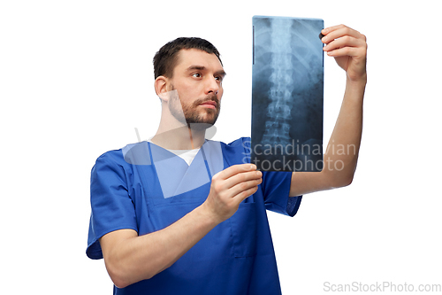 Image of doctor or male nurse looking at x-ray scan