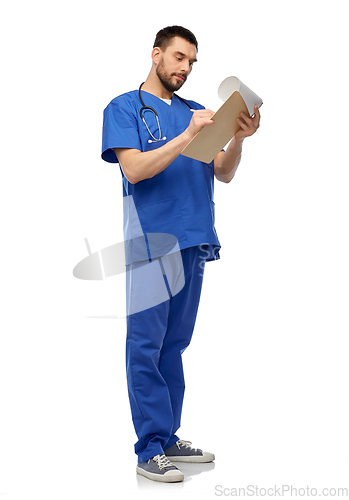 Image of male doctor writing medical report on clipboard