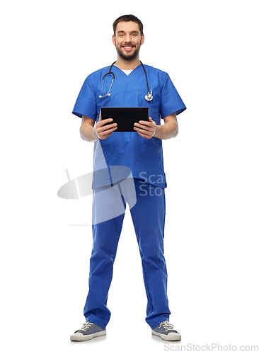 Image of smiling doctor or male nurse using tablet computer