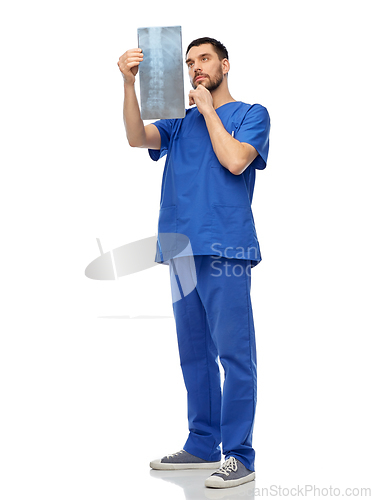 Image of doctor or male nurse looking at x-ray scan