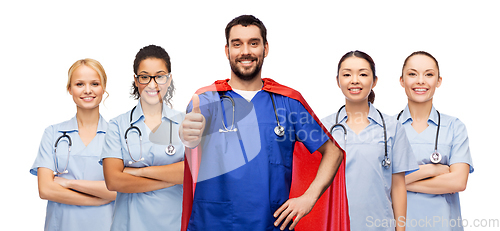 Image of happy doctor or nurse in superhero cape with team