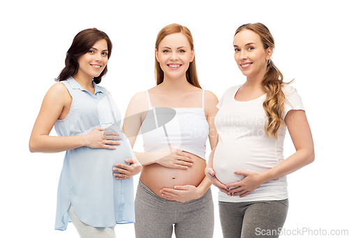 Image of happy pregnant women touching their big bellies