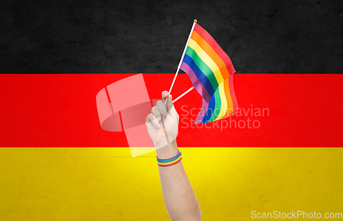 Image of hand with gay pride rainbow flags and wristband