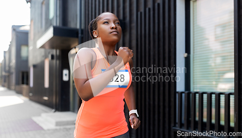 Image of young african american woman running marathon