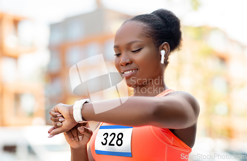 Image of marathon runner with earphones and smart watch