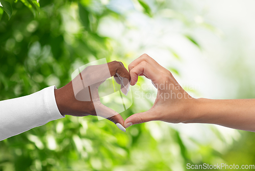 Image of black and white hands making heart gesture