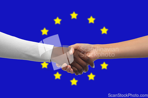 Image of handshake over flag of european union