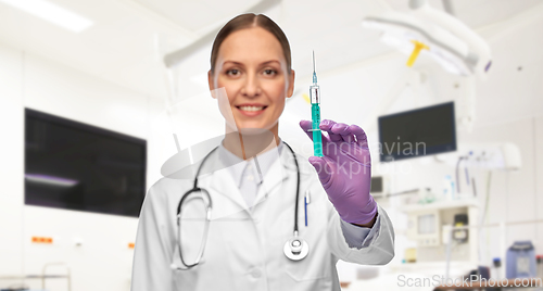 Image of female doctor with medicine in syringe at hospital