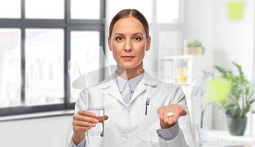 Image of female doctor with medicine and glass of water