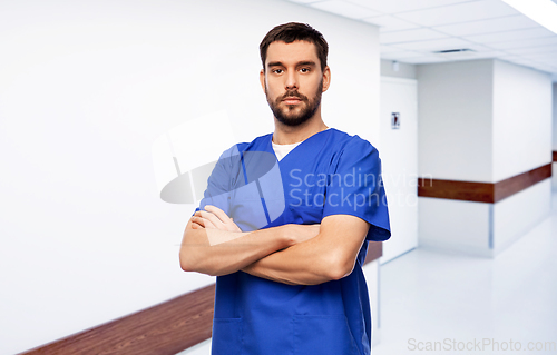 Image of doctor or male nurse in blue uniform