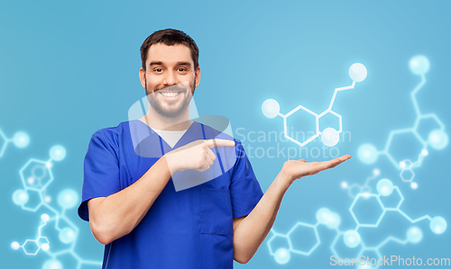 Image of smiling male doctor showing molecule formula