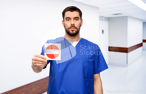 Image of doctor or male nurse showing stop sign