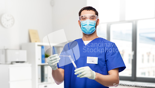 Image of male doctor in mask with cotton swab and test tube